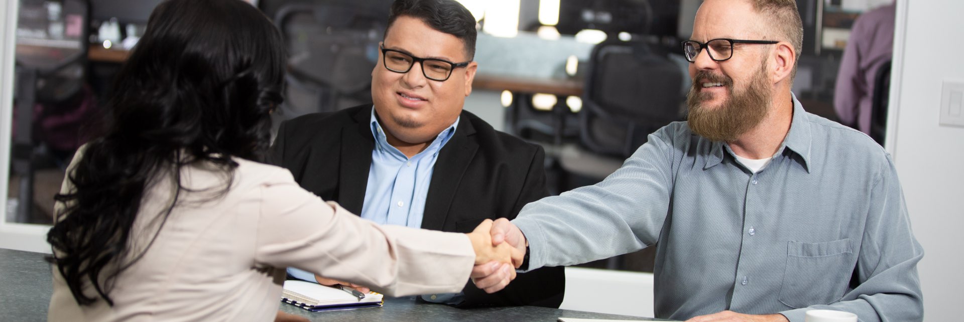 People in a meeting, shaking hands